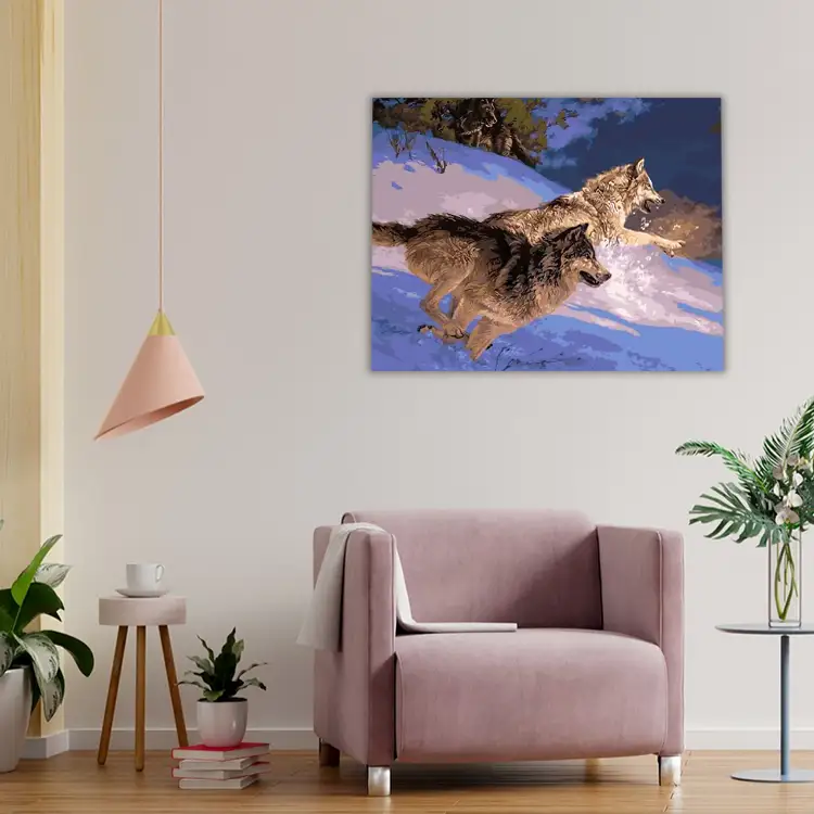 3 Two wolves running down snowy hill